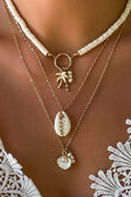 Handcrafted multi-layered necklace with shell and sunflower pendants in boho style