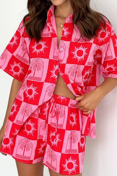 Red and pink checkerboard shorts set with sun and palm motifs, short-sleeve shirt and shorts