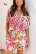 Woman in linen shorts set with vivid strawberry and lemon fruit-patchwork print