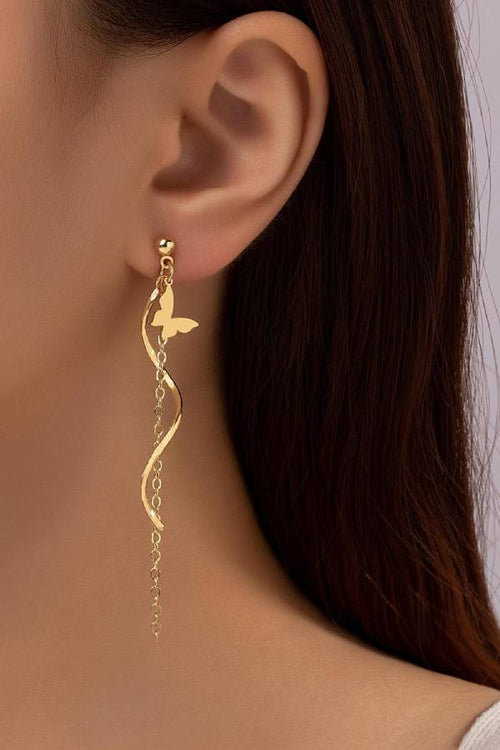 Gold-tone butterfly drop earrings with stainless steel posts on plain background