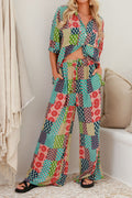 Model in a multicolor patchwork-print linen short-sleeve shirt and wide-leg pants set