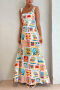 Woman in cream square-neck maxi sundress with colorful coastal patchwork print of anchors and palms