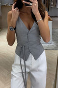 Gray V-neck sleeveless tie-waist top, hip-length, styled for casual everyday wear