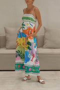 Model in a white linen cami maxi dress with a colorful coastal palm-and-sea-life print and square neck