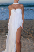 White strapless ruffle maxi dress with starfish accent and high front slit on the beach