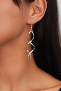 Gold twisted chunky hoop earrings with a bold sculpted minimalist design
